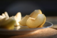 slices of asian pear on a glass plate