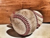 close up of three baseballs, dirty from use