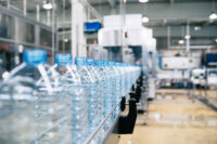 Water bottling line for processing and bottling pure spring water into green glass small bottles.